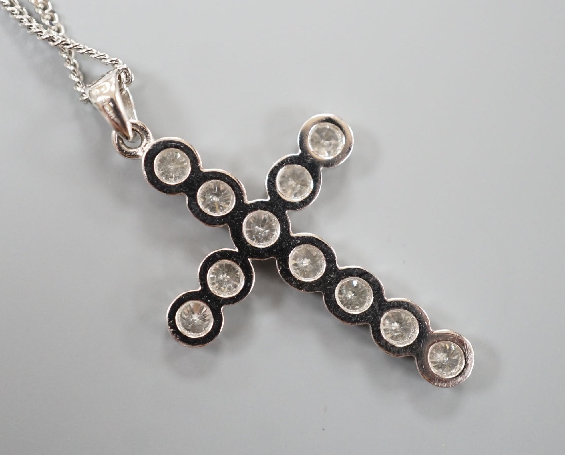 A modern 18ct white gold and diamond set cross pendant, 39mm, on an 18ct white gold chain, 44cm, gross weight 7.1 grams.